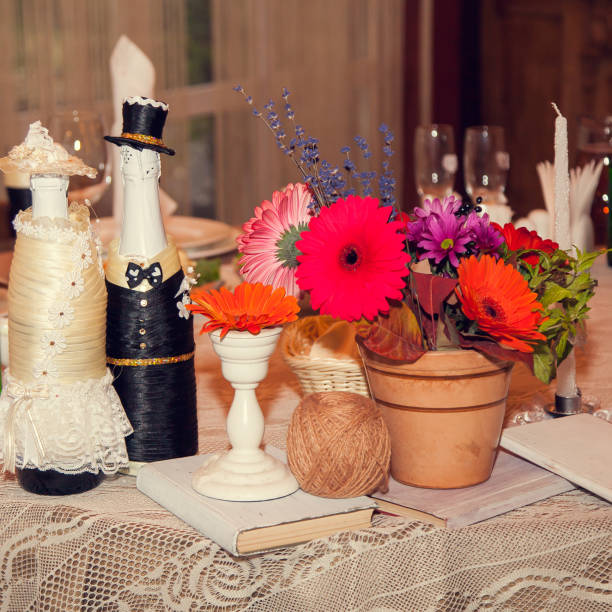 autumn rustic wedding decor with flowers on the table of the bride and groom in a restaurant at a festive banquet - burlap canvas home decorating color image imagens e fotografias de stock