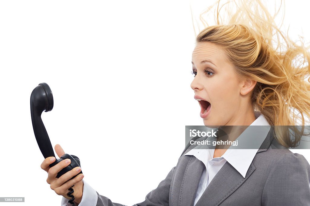 Surprised businesswoman Surprised businesswoman with telephone. Isolated on white background. Blowing Stock Photo