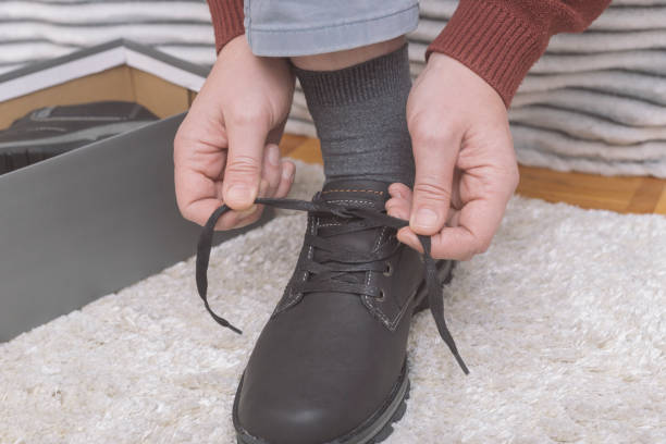 istock Man unboxing and trying new pair of shoes 1380311069