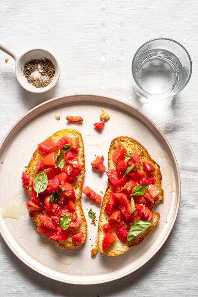 Italian bruschetta Italian bruschetta with tomatoes, oil and oregano, on a plate. Top view. bruschetta stock pictures, royalty-free photos & images