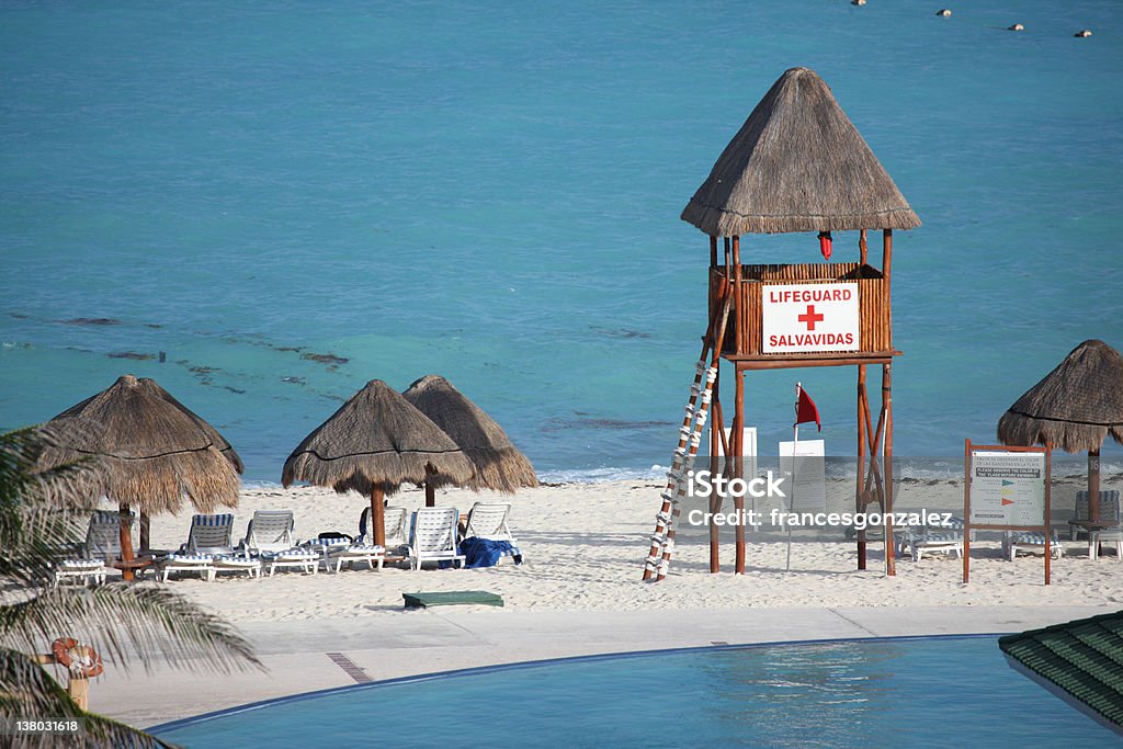 Caribbean Beach and Lifeguard caribbean beach and pool along with cabanas and lifeguard Cancun Stock Photo