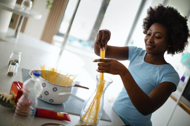 istock Young woman is cooking lunch in the kitchen. 1380333964