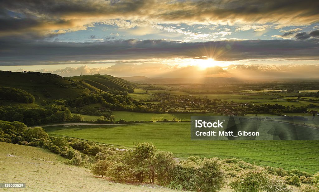 Stunning Summer sunset over countryside escarpment landscape Landscape over English countryside landscape in Summer sunset Color Image Stock Photo