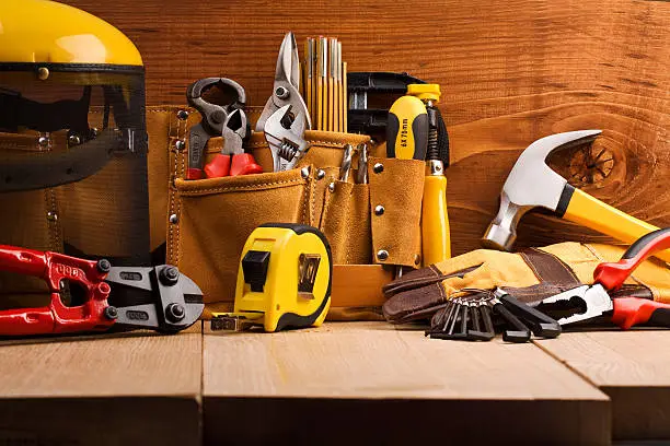 Photo of Various working tools on wooden planks