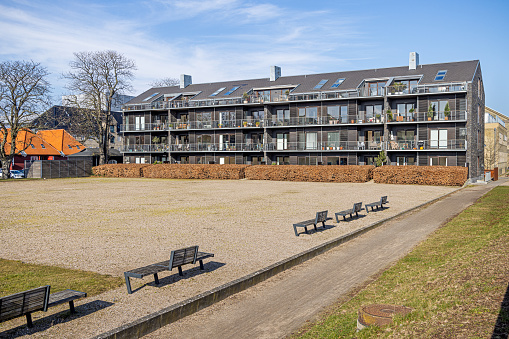 Modern Danish residential building on a clear day of early spring. It is situated in a newly developed par of Copenhagen which used to be a naval base