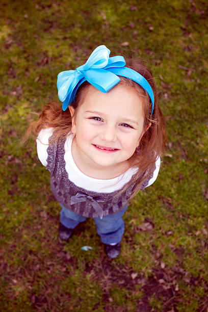 Young beautiful 3 years old girl in the park stock photo