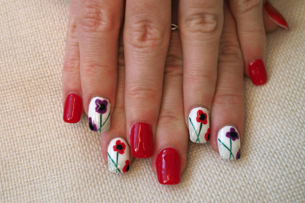istock Painted acrylic nails with poppy remembrance theme 1380378608