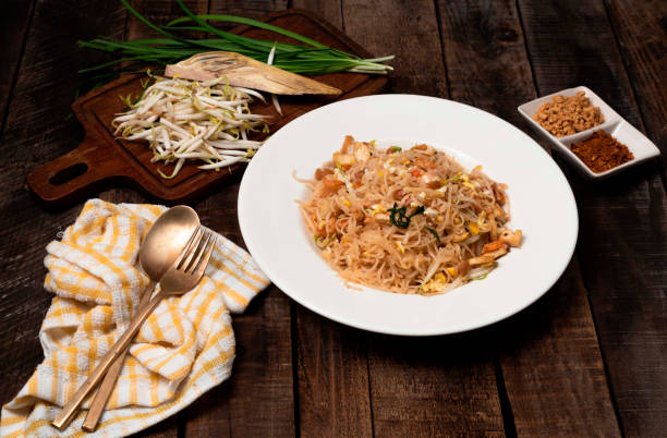 istock Fried rice noodle Pad thai has egg vegetable on wood table. 1380405341