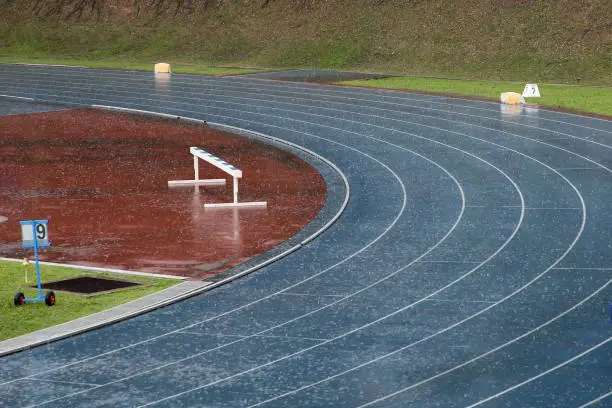 Empty sports track - Competitions at track and field stadium delayed due to non-stop rains.