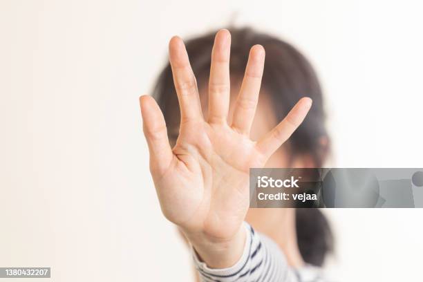 Hand Gesture Stop No Woman Rises Her Hand Up Covering Her Face And Showes Stop Gesture By Hand Trying To Stop Any Coming Danger Nonverbal Language Sign Stock Photo - Download Image Now