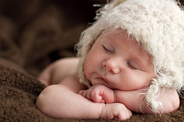 newborn baby boy sleeping stock photo