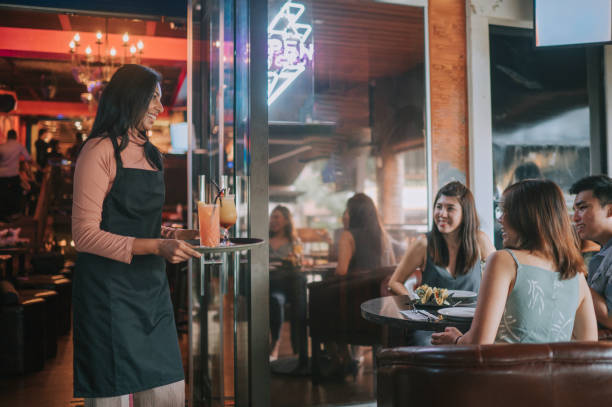 istock asian indian waitress serving cocktail to her customer at pub during happy hour 1380461548