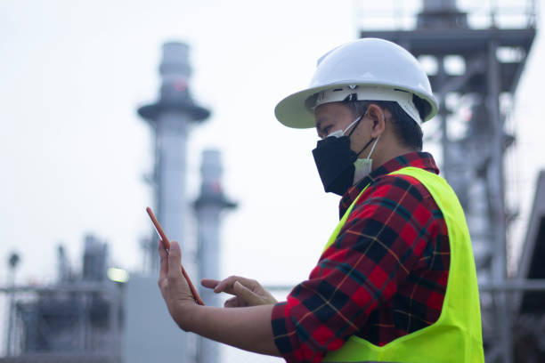 istock Engineer wearing mask working and laptop at power plant 1380468112