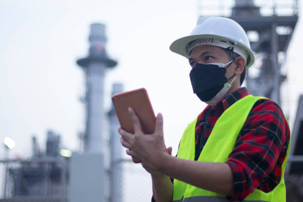 istock Engineer working and laptop at power plant in the evening 1380468380