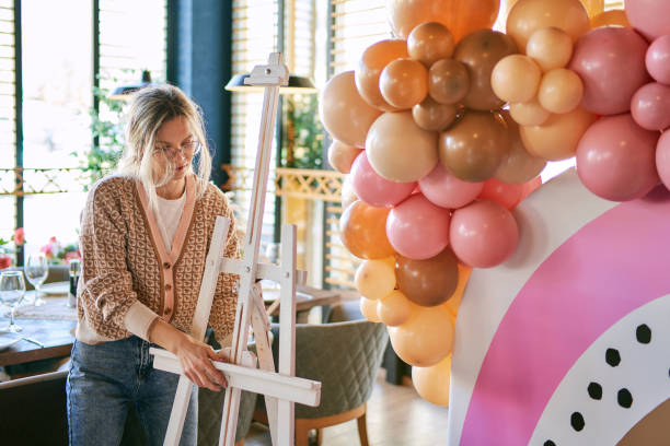 istock Female party planner arranging balloon decoration 1380489925