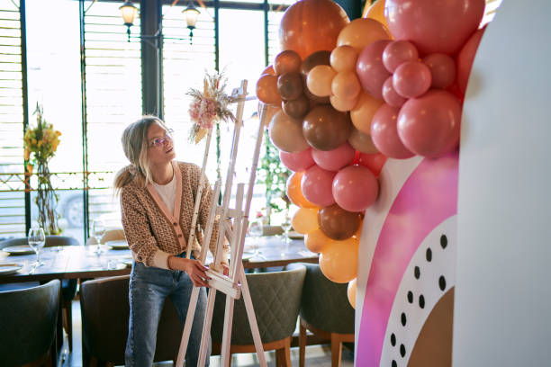 istock Female party planner arranging balloon decoration 1380489927