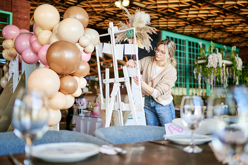 Female party decorator arranging decorations for a child birthday party