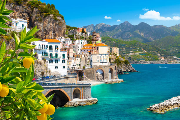 Beautiful view of Amalfi on the Mediterranean coast with lemons in the foreground, Italy Morning view of Amalfi cityscape on coast line of mediterranean sea, Italy amalfi coast photos stock pictures, royalty-free photos & images