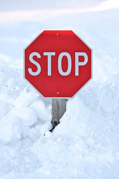 Stop sign buried in snow drift stock photo