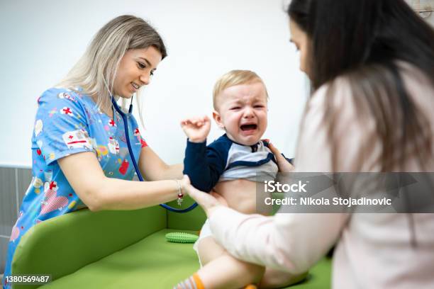 Doctor Examining Baby Boy Stock Photo - Download Image Now - Crying, Doctor, Child