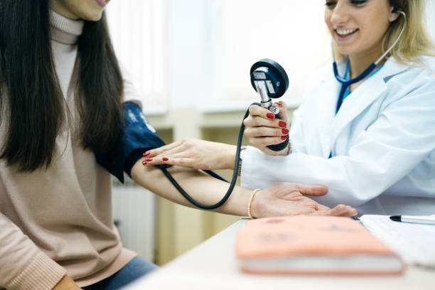 istock The doctor measures the patient's pressure 1380575460