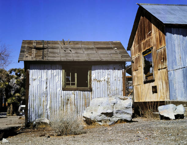 Abandoned house in a ghost town Abandoned house in a ghost town in the middle of the desert alongside the old Route 66 between Arizona and New Mexico boarded up photos stock pictures, royalty-free photos & images