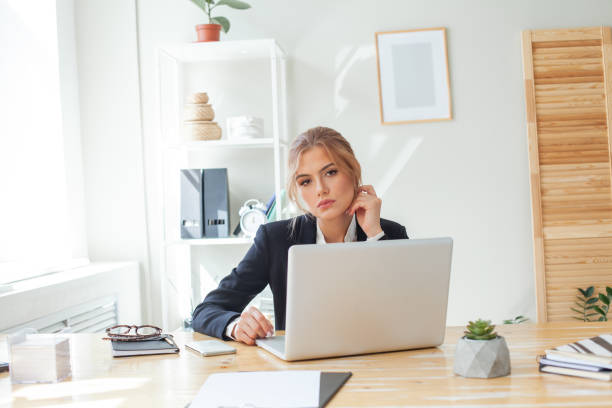 istock Tired business woman looking at camera in her office 1380590934
