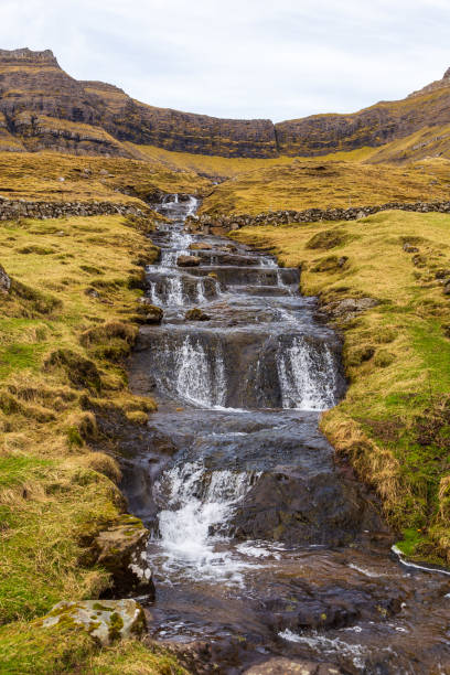 istock A waterfall flowing down a steep mountain slope on Bordoy Island, Faroe Islands. 1380594722