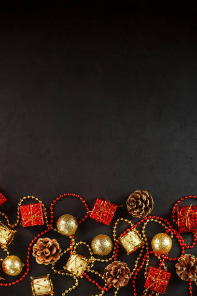 istock Christmas decorations in gold and red on a black background with free space. 1380595531