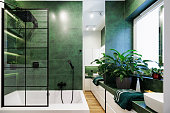 Green luxury bathroom, black rain shower head.