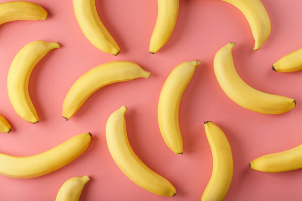 istock Bright pattern of yellow bananas on a pink background. 1380596353