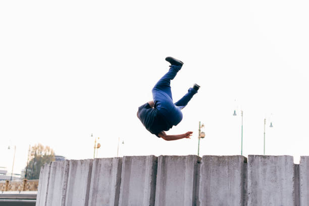 istock Caucasian man trains parkour while jumping over a high top. 1380604270
