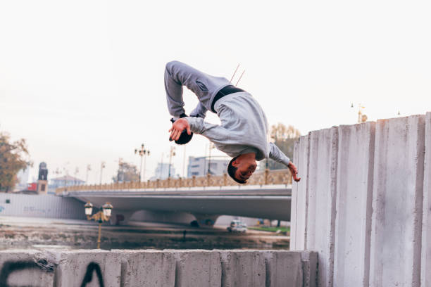 istock Young man practicing parkour at the city park,doing tricks and jumps. 1380604287