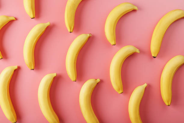 istock Bright pattern of yellow bananas on a pink background. 1380606664