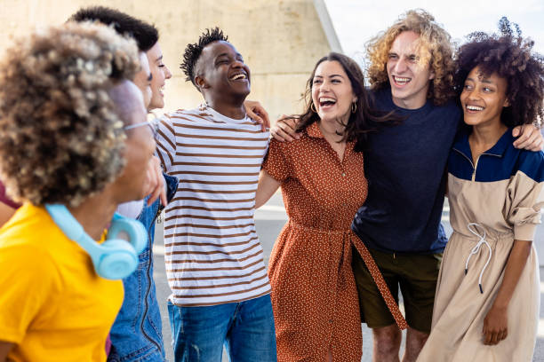 istock Multi-ethnic young friends laughing together outdoors 1380606758