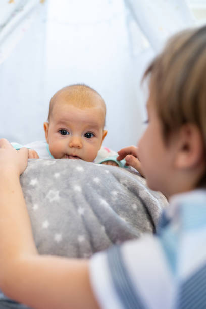 istock Boy playing whit his baby sister 1380606915