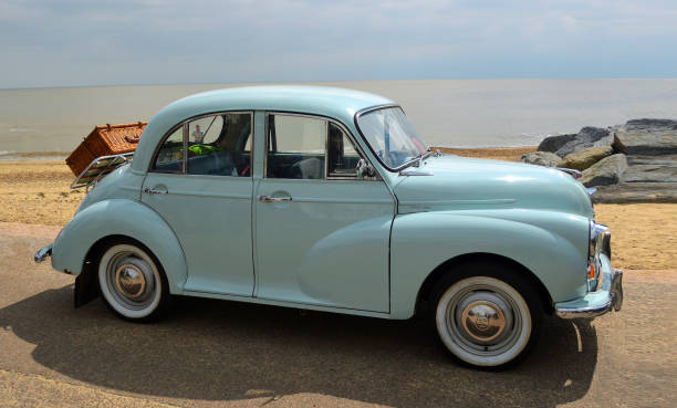 Felixstowe, Suffolk, England -  May 07, 2017: Classic Light Blue Morris Minor with picnic basket parked on seafront promenade.