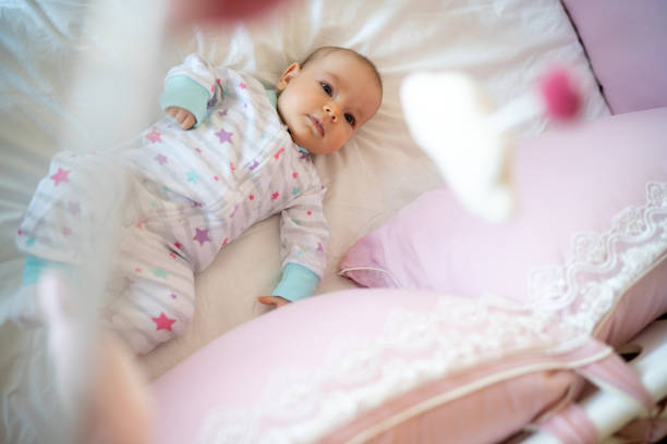 istock Baby girl lying in crib 1380616816