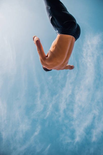 istock Free runner trains parkour below blue sky 1380617531