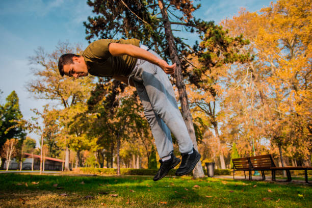 istock Stuntman exercising parkour workout in park 1380617553
