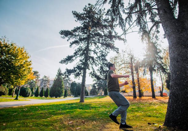 istock Free runner trains parkour below blue sky 1380617566