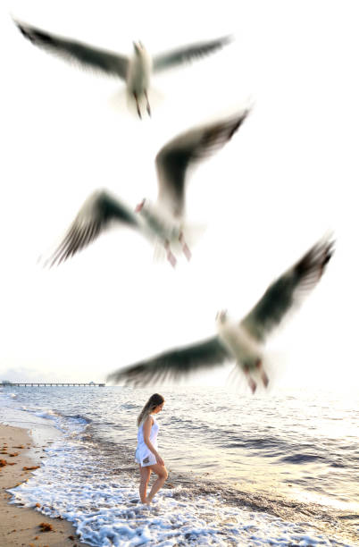 istock Happy young blond woman walking at beach 1380621834