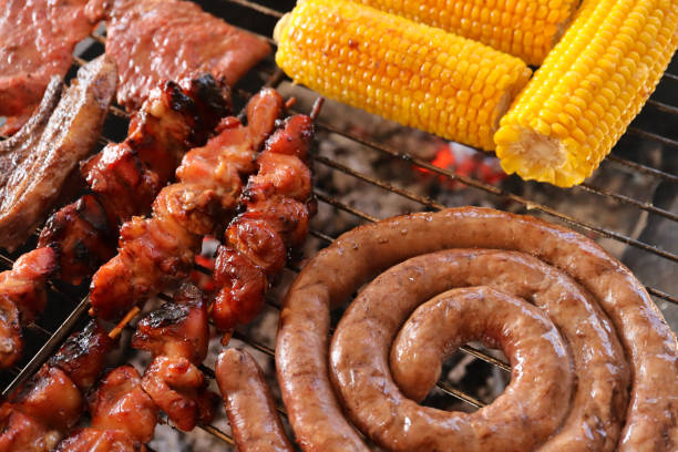 South African braai A South African braai or barbecue with boerewors sausage, chicken kebabs, lamb chops, steak and mielies or maize on a grill south african braai stock pictures, royalty-free photos & images