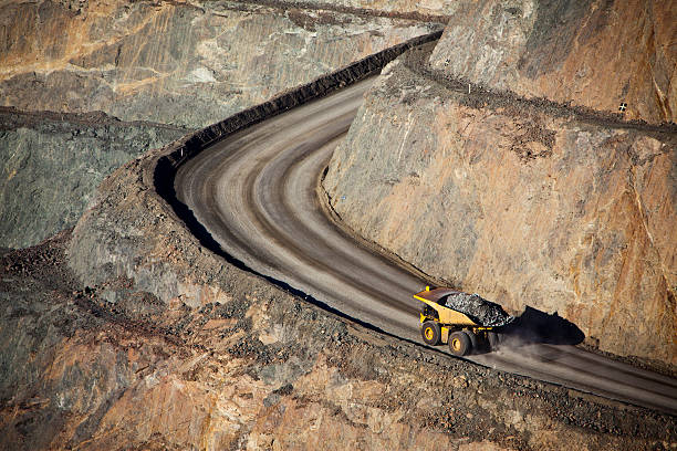 Gold Mine Modern Gold Mine in Kalgoorlie, Western Australia. Large truck transports gold ore from the Super Pit, Open cast mine. gold mine photos stock pictures, royalty-free photos & images