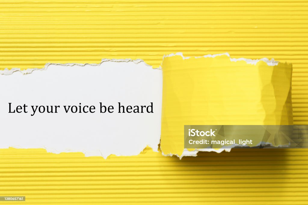 Let your voice be heard written under torn paper Listening Stock Photo