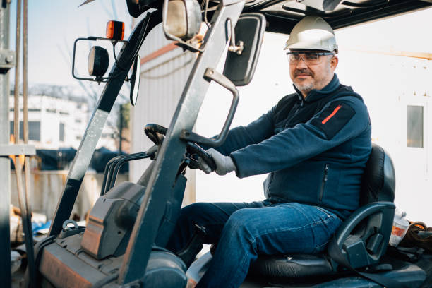 istock Worker driving forklift in factory stock photo 1380671348