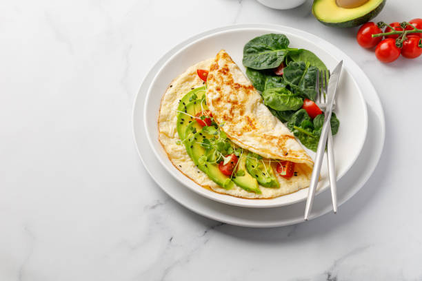 istock Omelet with vegetables, avocado and cherry tomatoes. Omelette. Copy space 1380679910