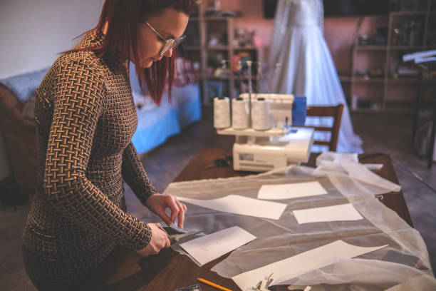 istock Cutting out pieces of textile of constructed garment 1380683117