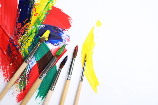 istock Brushes with different paints and strokes on white background, flat lay. Space for text 1380702567