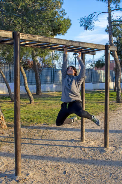 istock Teenage doing exercise in a park with parallel bars 1380703715